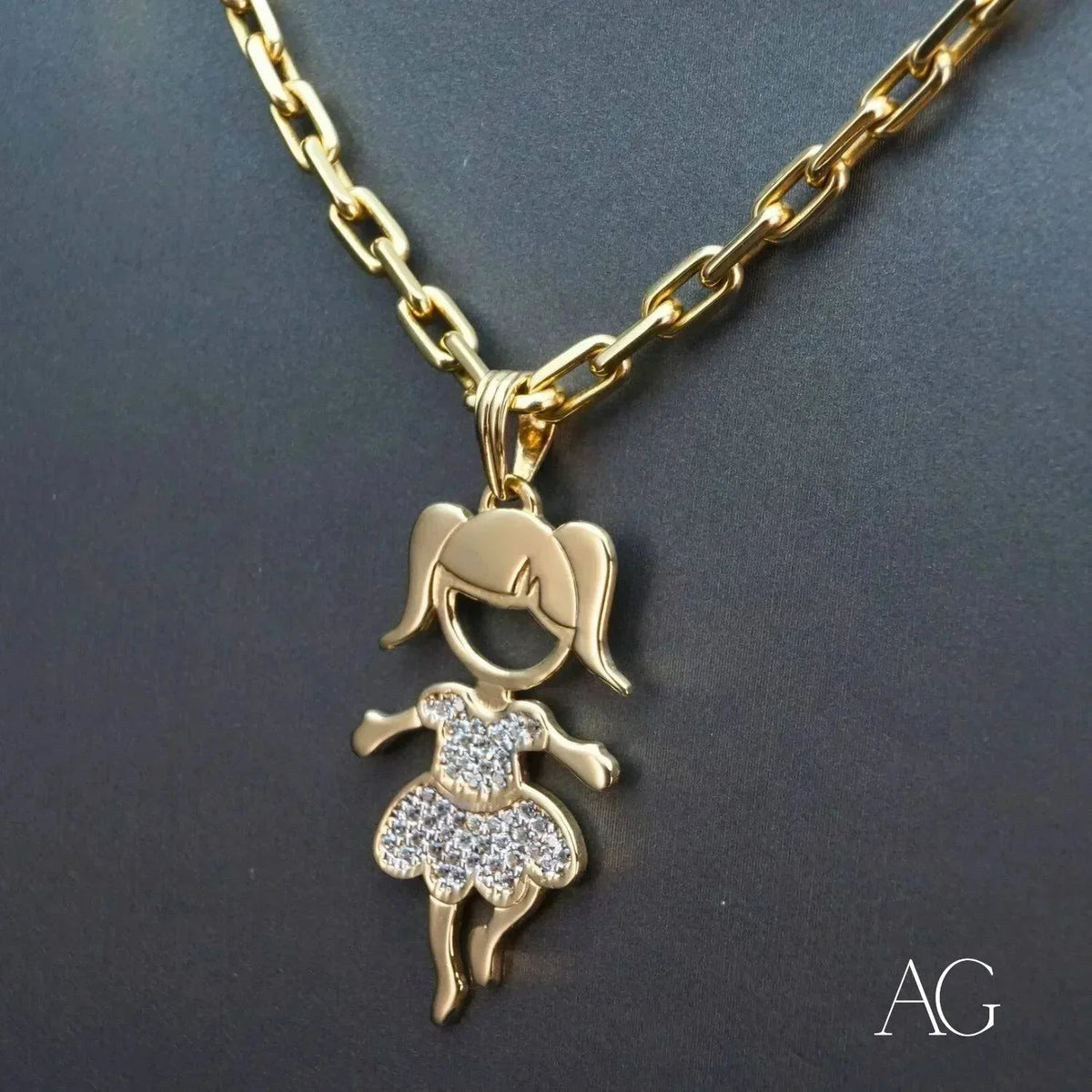 Enchanting 18K gold Girl doll pendant with CZ dress hanging from a gold chain