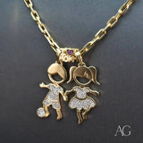 Enchanting Boy and Girl 18K gold doll pendants with CZ displayed together on a chain