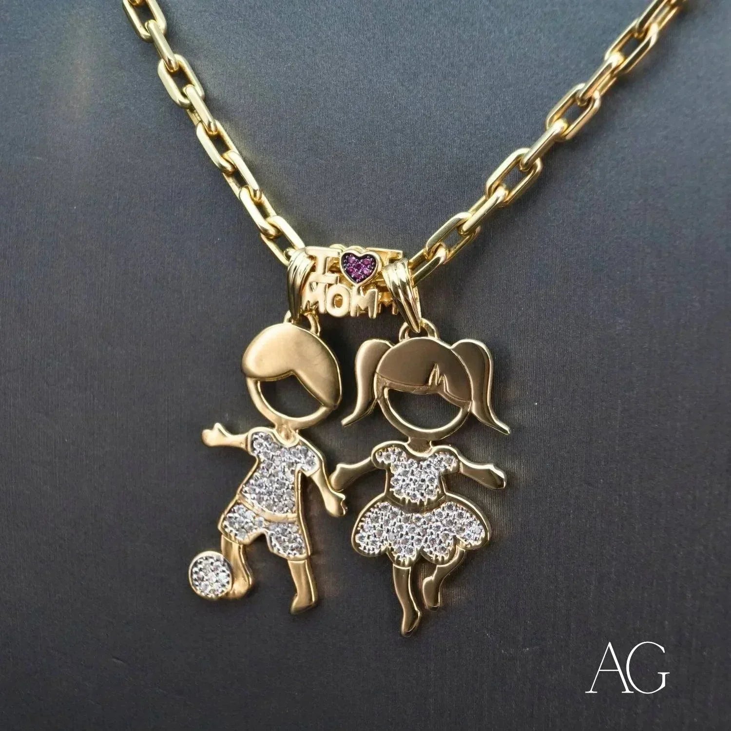 Enchanting Boy and Girl 18K gold doll pendants with CZ displayed together on a chain