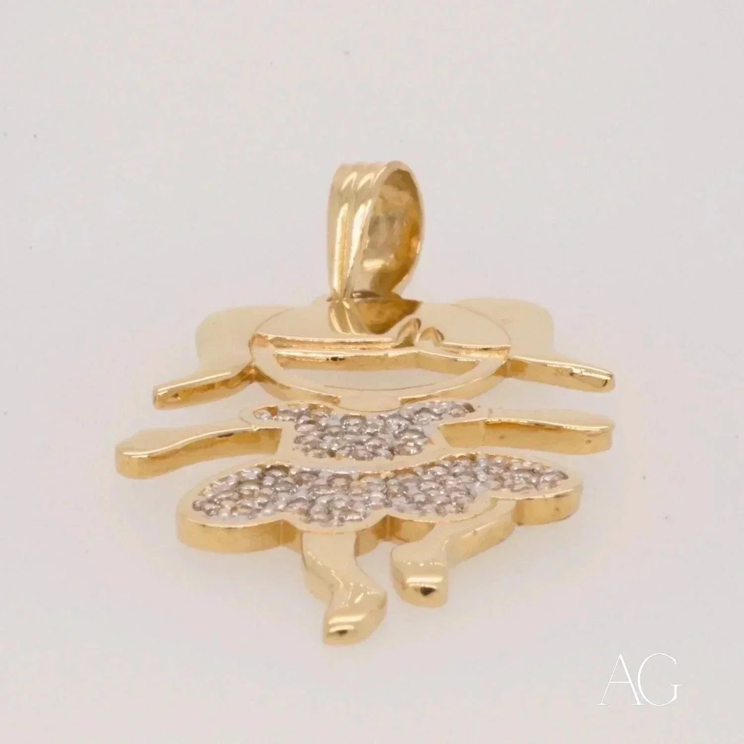 Low-angle view of Enchanting 18K gold Girl doll pendant with CZ dress