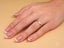 Close-up of a woman’s hand with essence linea 2mm ring and art gold jewelry detail