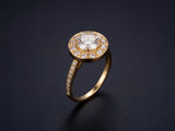 Star halo engagement ring in 18K gold, three-quarter view with diamond center and pavé band