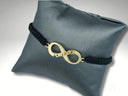 Stunning 18k gold infinity bracelet with black braids and FOREVER charm