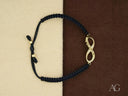Stunning 18k gold infinity bracelet with black braided cord and diamond charm