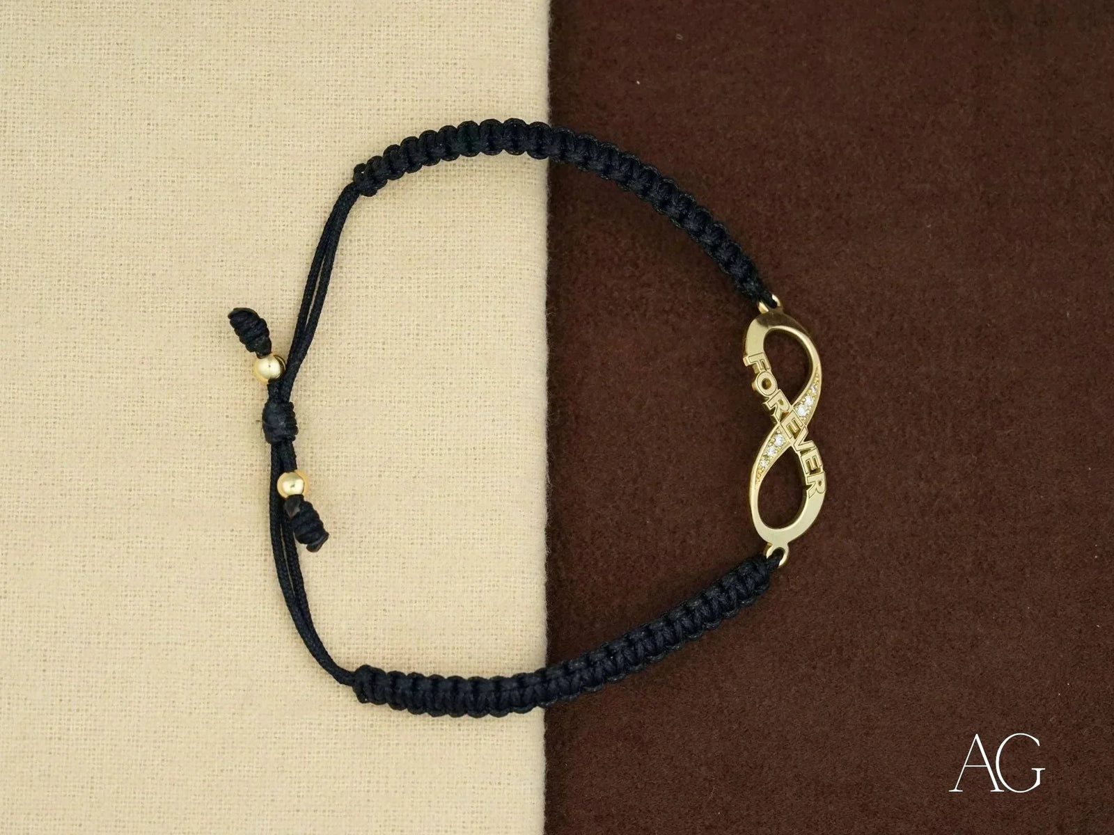 Stunning 18k gold infinity bracelet with black braided cord and diamond charm