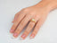Eternal Embrace Engagement Ring with halo design and eternal love diamond on woman’s hand