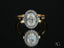 Eternal Halo Engagement Ring featuring an oval diamond with a delicate halo on a yellow gold band
