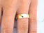 Polished gold wedding band on finger from Eternal Love 18k collection, crafted in 18k solid gold