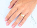 Eternal Love 18k solid gold wedding band on woman’s hand with pink French tips