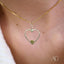 Gold heart pendant with smaller heart inside on delicate chain, elegant heart design, eternal love pendant