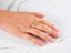 Eternal Radiance Ring with cubic zirconia stones and timeless elegance on a hand with French-tipped nails