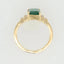 Gold ring with emerald-cut green gemstone and diamond accents, a rare emerald encounter art in Greater Boston area