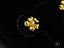 Gold flower-shaped stud earring with 0.06ct diamond center, perfect for floral elegance earrings