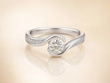 Front view of bypass diamond ring with pavé shoulders and center stone