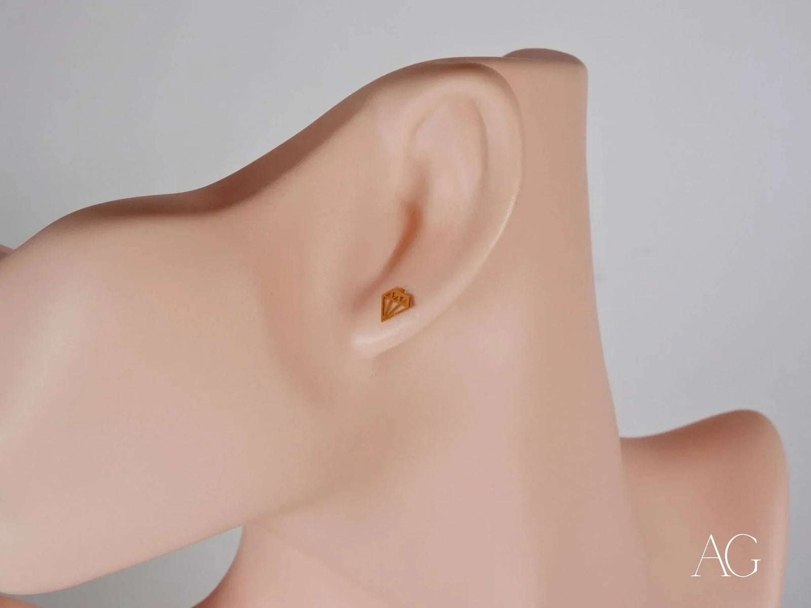 Certified 18k solid gold geometric diamond earring on ear mannequin