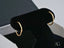 Glimmergold 18k mini hoop earrings on black velvet display for everyday elegance