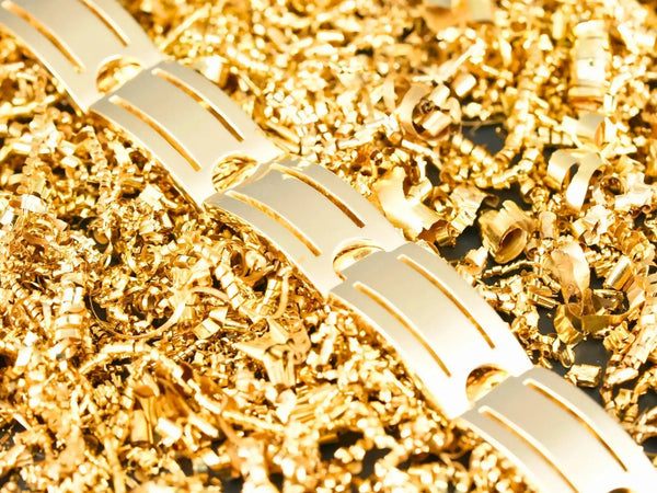 Gold bracelet with geometric patterns and textured surface.