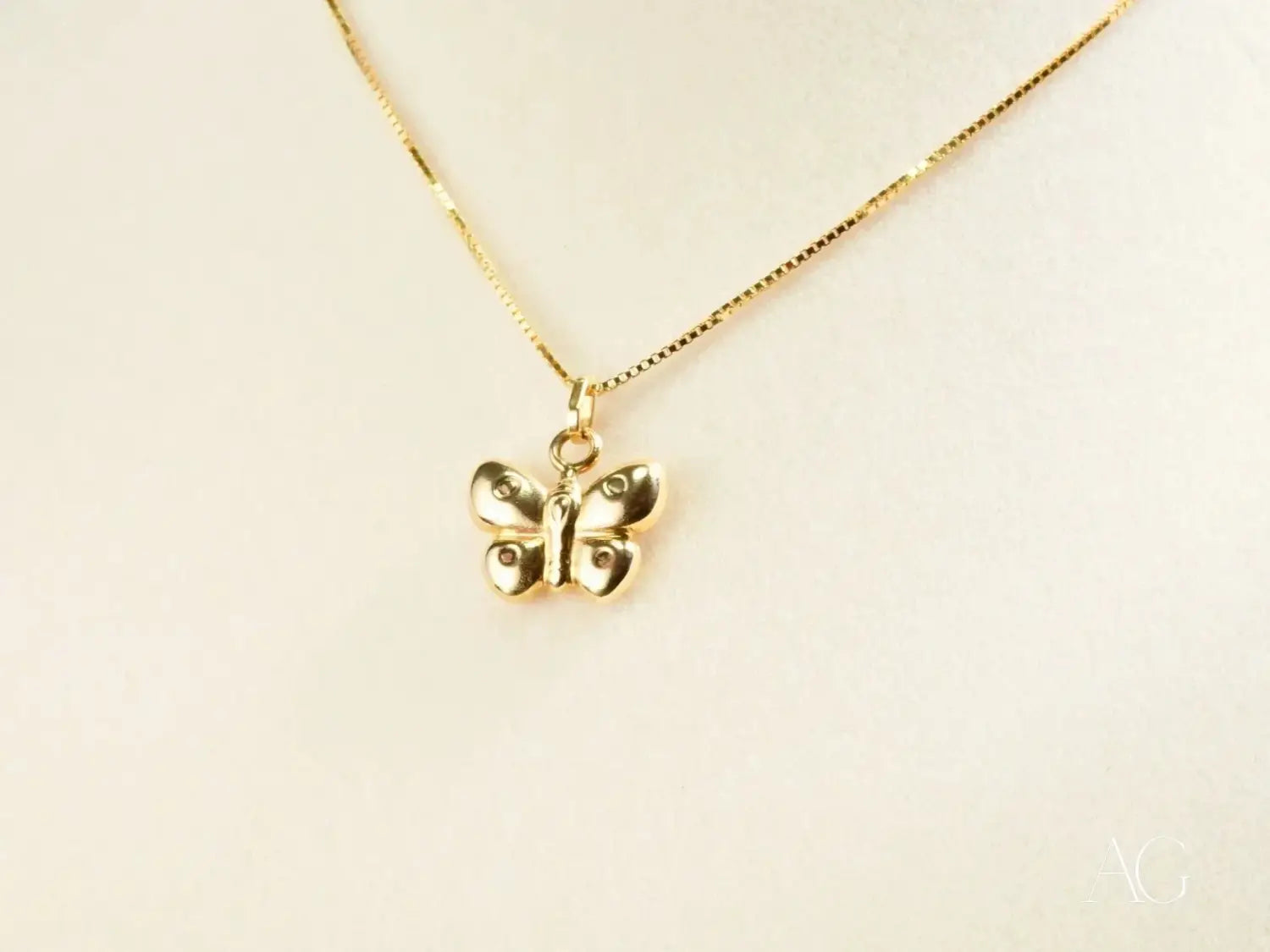 Gold butterfly pendant necklace with delicate box chain, luxury jewelry.