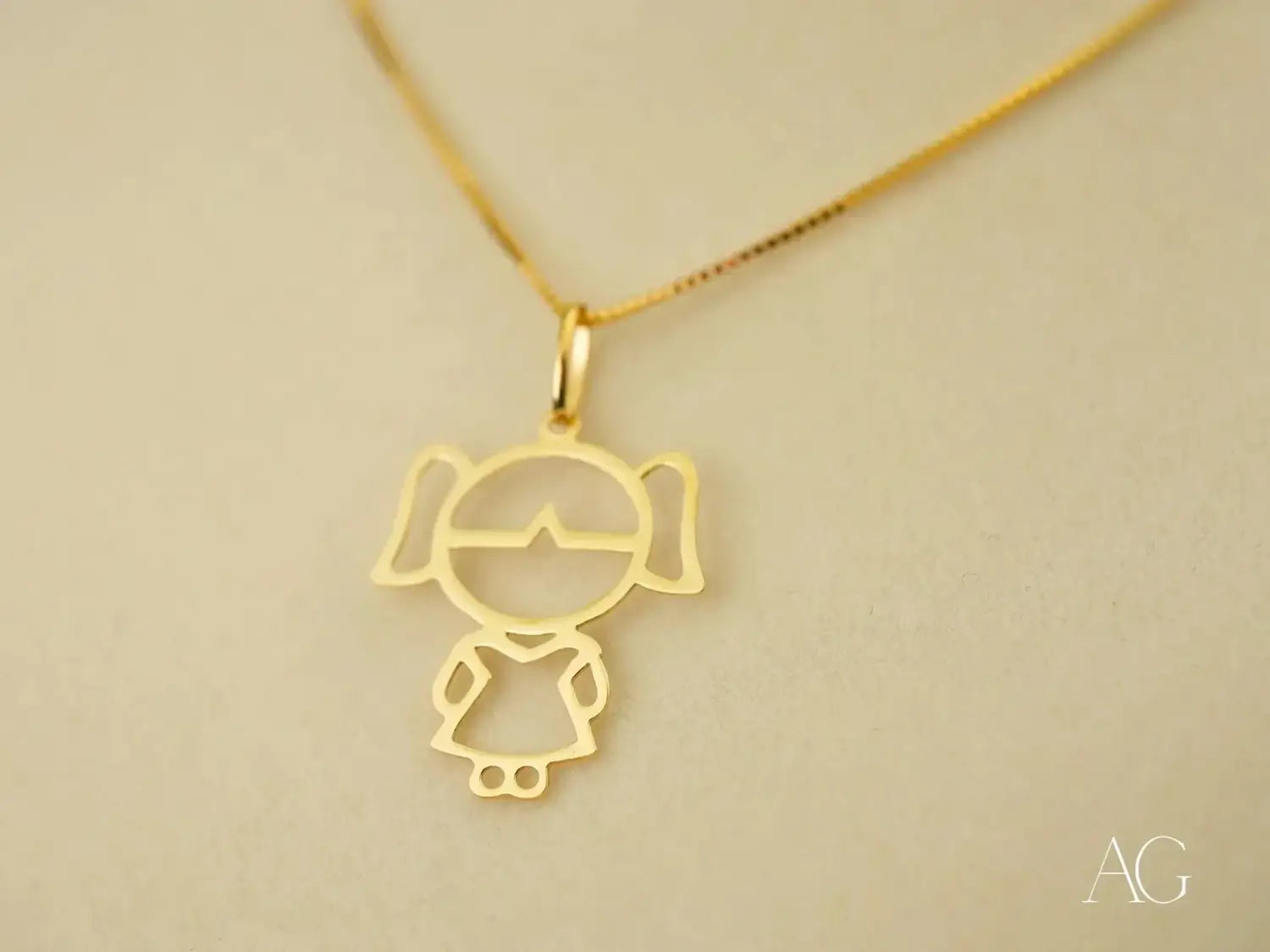 Van Cleef gold minimalist pendant necklace with stylized girl in pigtails