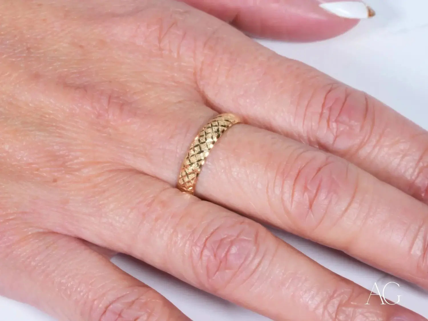 Gold-colored 18k gold ring featuring a textured woven diamond pattern showcased in an editorial spotlight on the best gold jewelry stores in Massachusetts gems and jewelry.