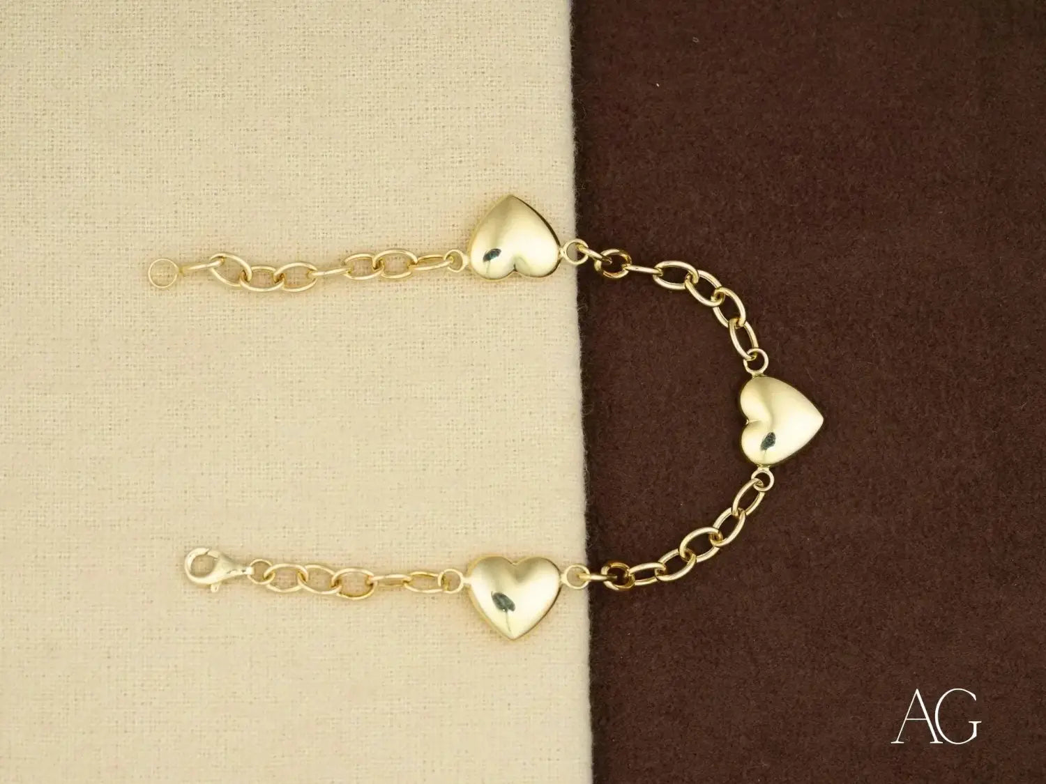Stunning 18k gold heart charm bracelet at Art Gold Jewelry in Everett