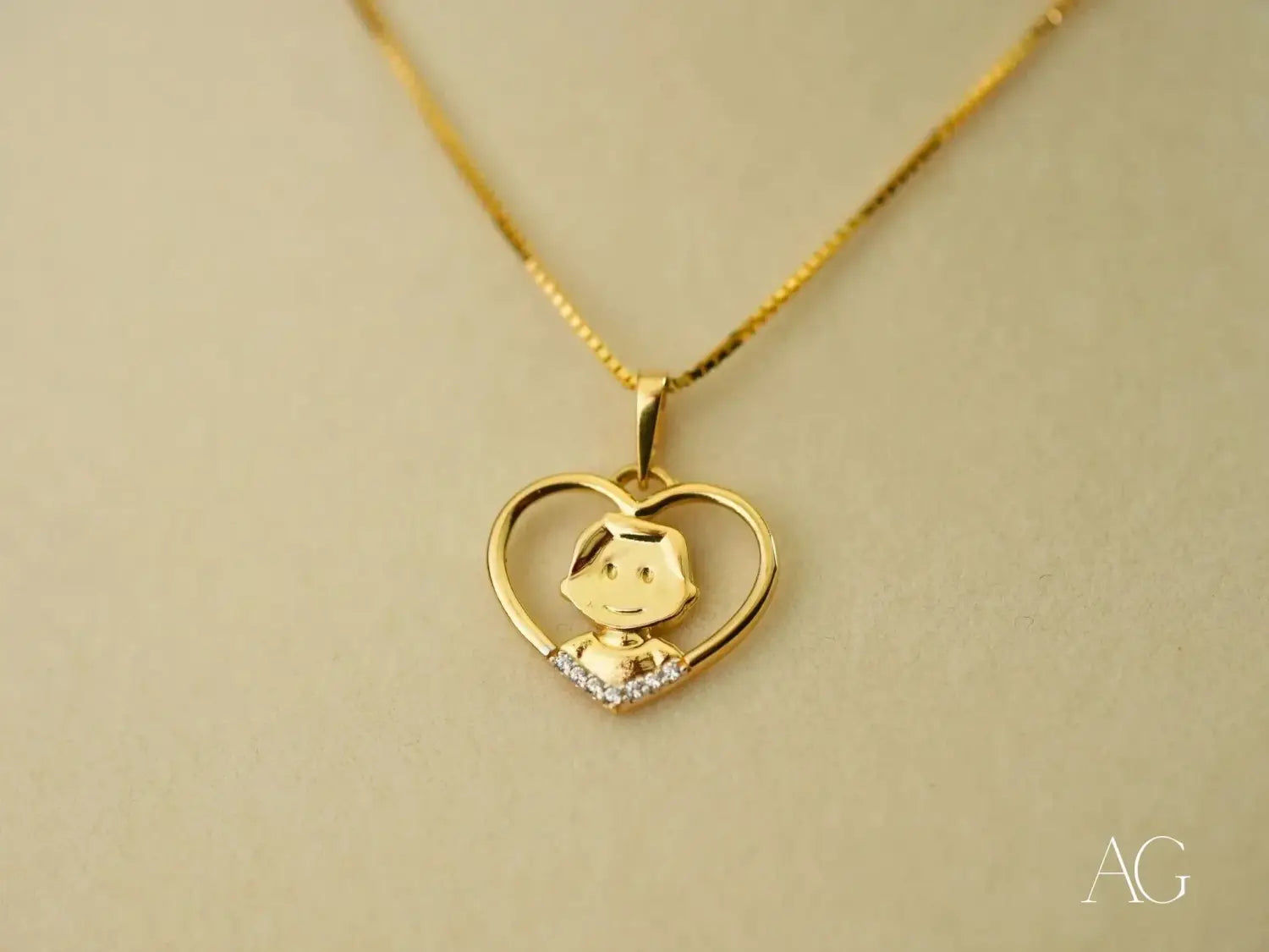 gold heart-shaped pendant necklace featuring a smiling cartoon figure and clear stones along the bottom edge in fine jewelry made from 18k gold ideal for gold jewelry collections.
