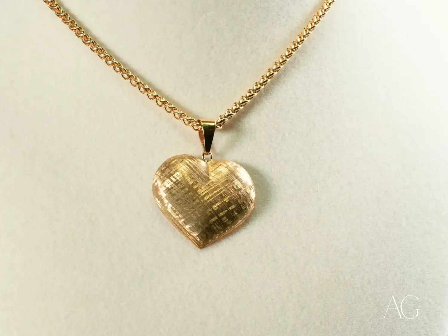 Gold heart pendant with woven texture on chain, art gold jewelry.
