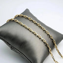 18k diamond-cut open gold chain with rectangular links on dark pillow