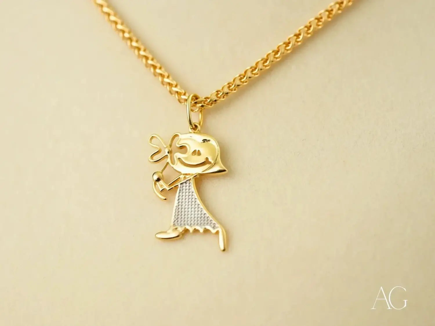 Golden Elegance: Gold Doll Pendant