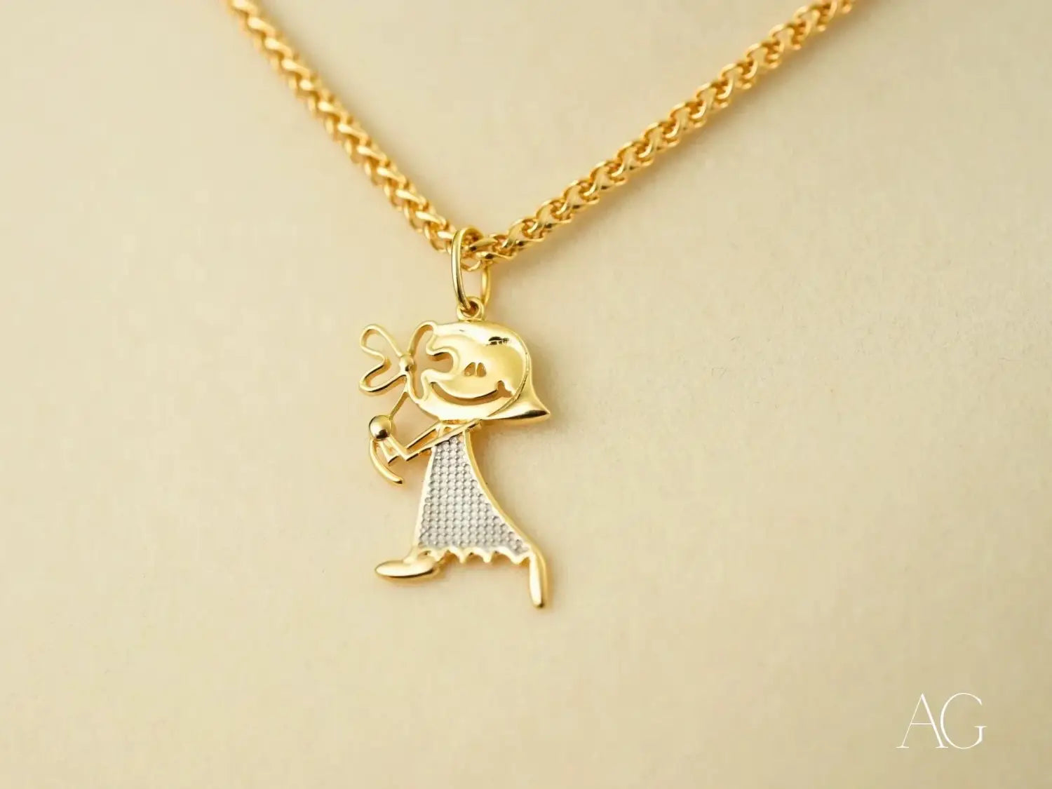 Golden Elegance: Gold Doll Pendant