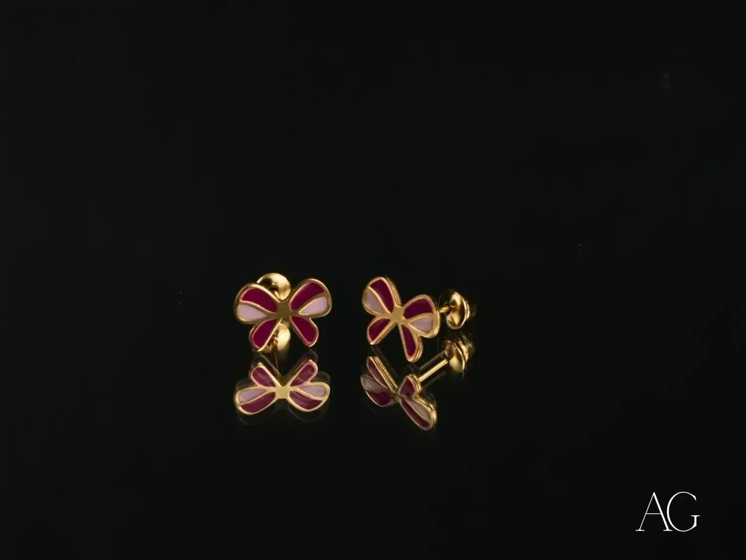 gold-tone butterfly-shaped stud earrings featuring vibrant red and soft pink enamel petals as a fine jewelry piece highlighted in an article on unique styles insights into mikimoto pearls and david yurmans craft luxury jewelry collection