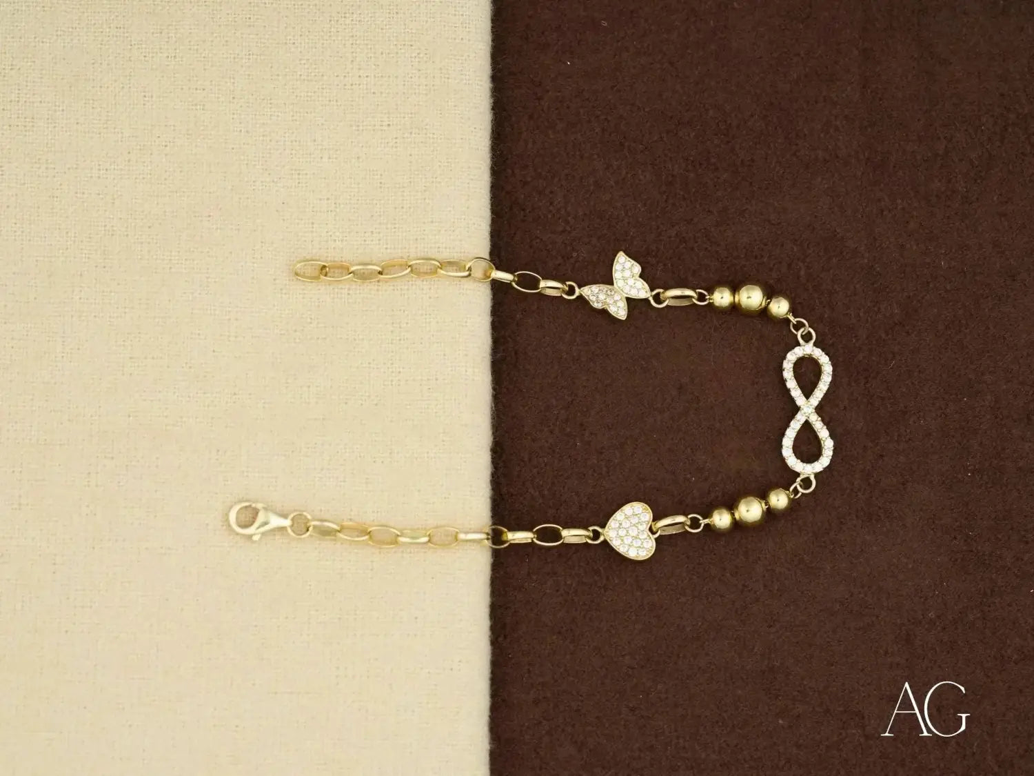 Stunning 18k gold bracelet with diamond infinity and heart charms