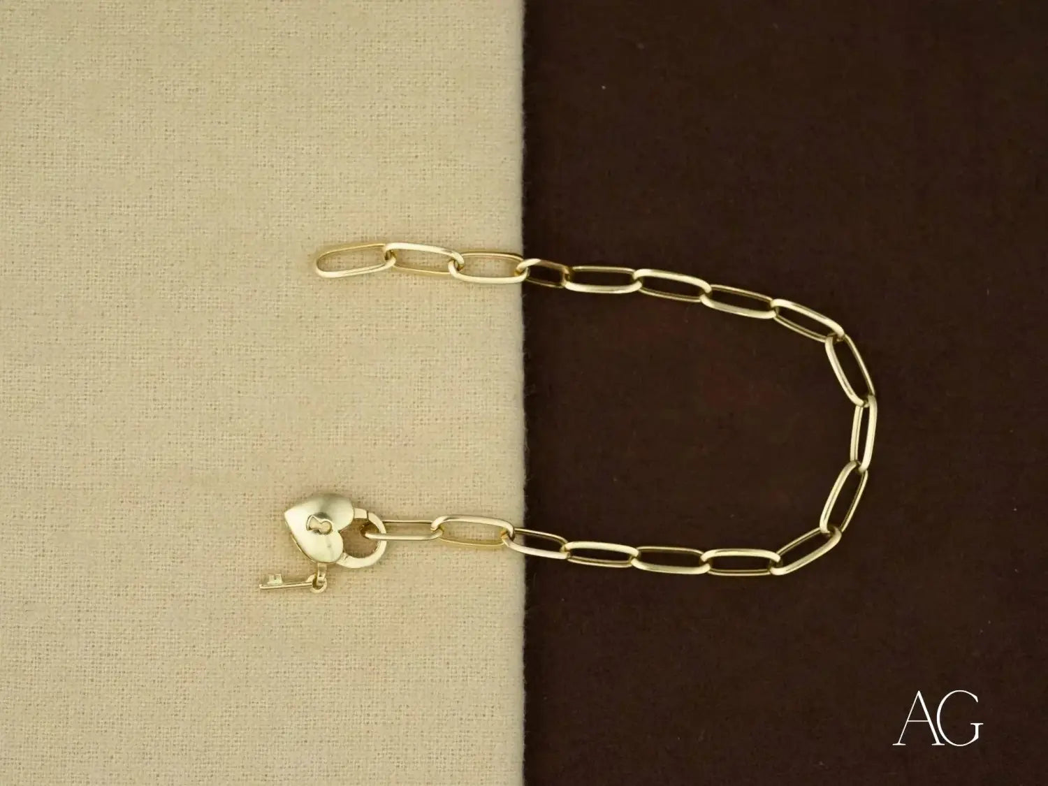 Gold paperclip chain bracelet with heart lock, inspired by Fabergé eggs