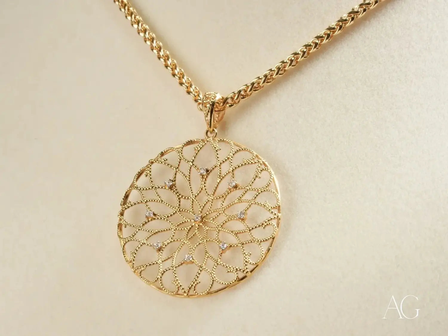 Van Cleef gold-toned filigree pendant with clear gemstones