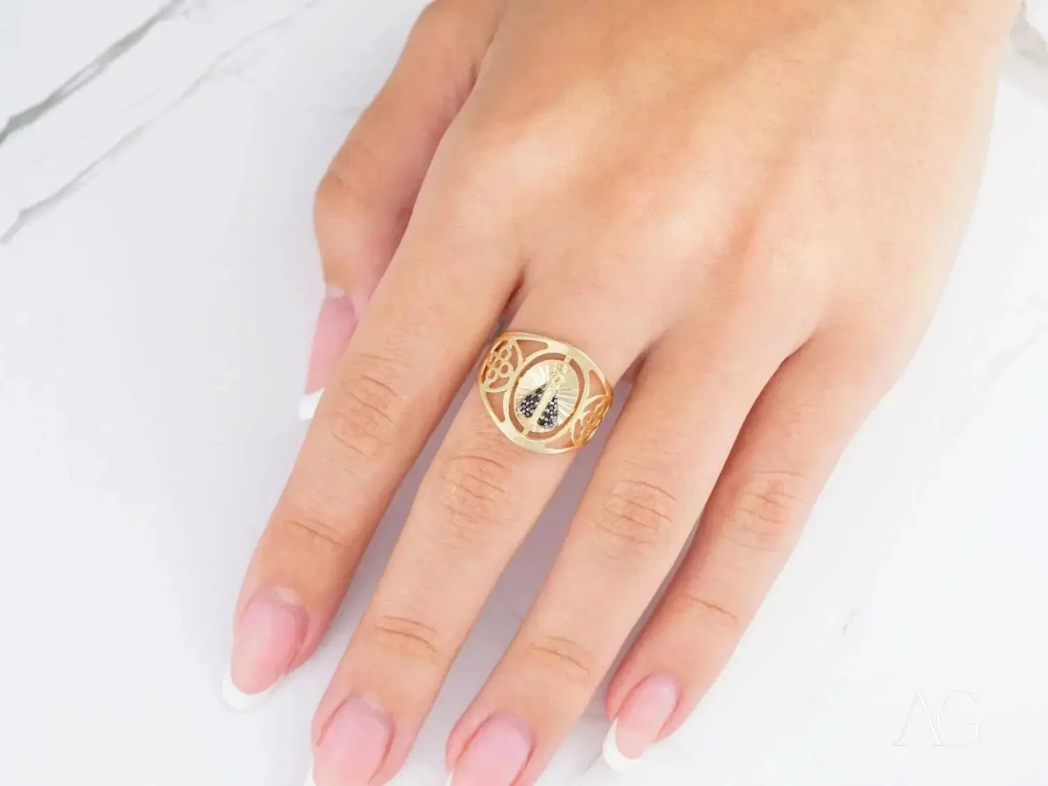 Ethical 18k gold ring with ornate openwork and black white emblem