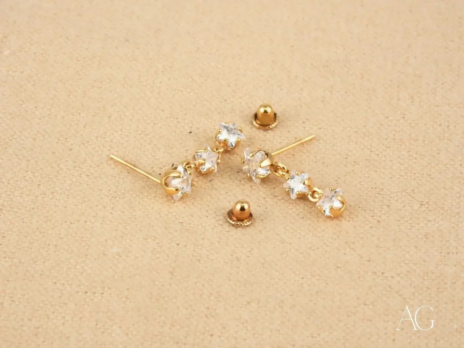 Gold-toned star stud earrings with crystal accents in art gold jewelry style