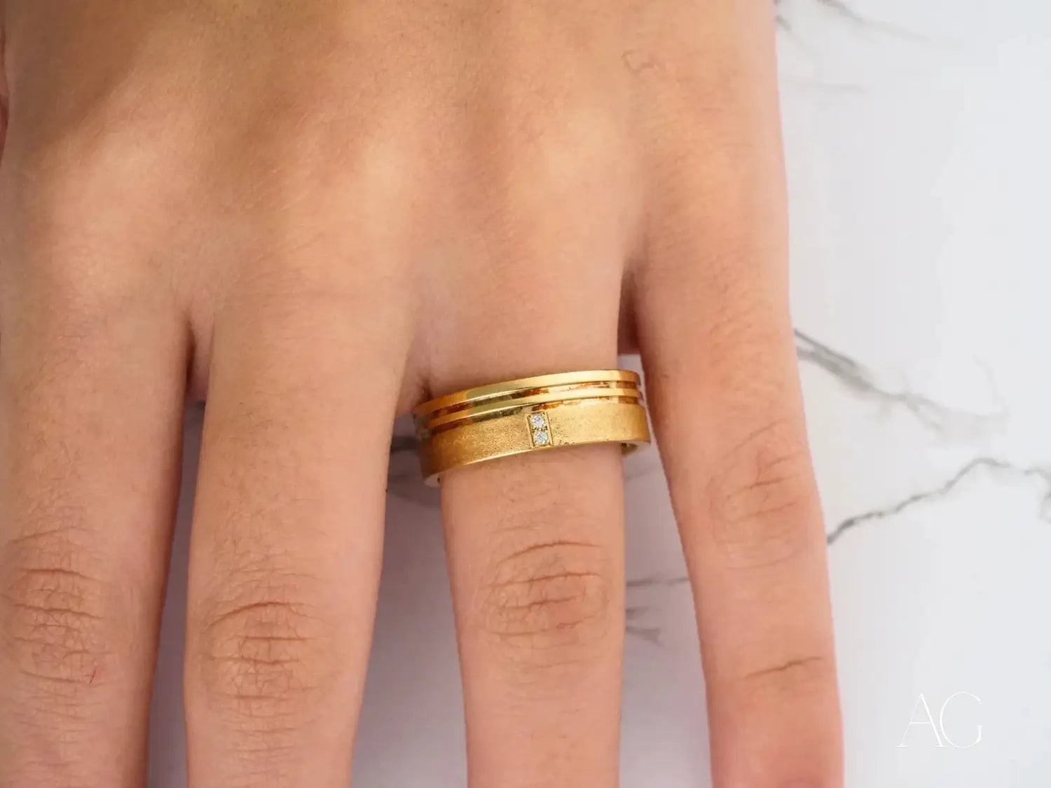 a person wearing a pink hijab and matching jacket adorned with fine 18k gold jewelry rings symbolizing meaning wrapped in metal