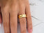 Golden Cascade Wedding Band showcasing polished gold finish and comfort fit design