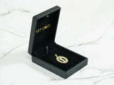 Golden Charm 18k gold CZ boy pendant in open black velvet box