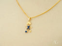 18k solid gold charm pendant of boy playing soccer with blue CZ gems
