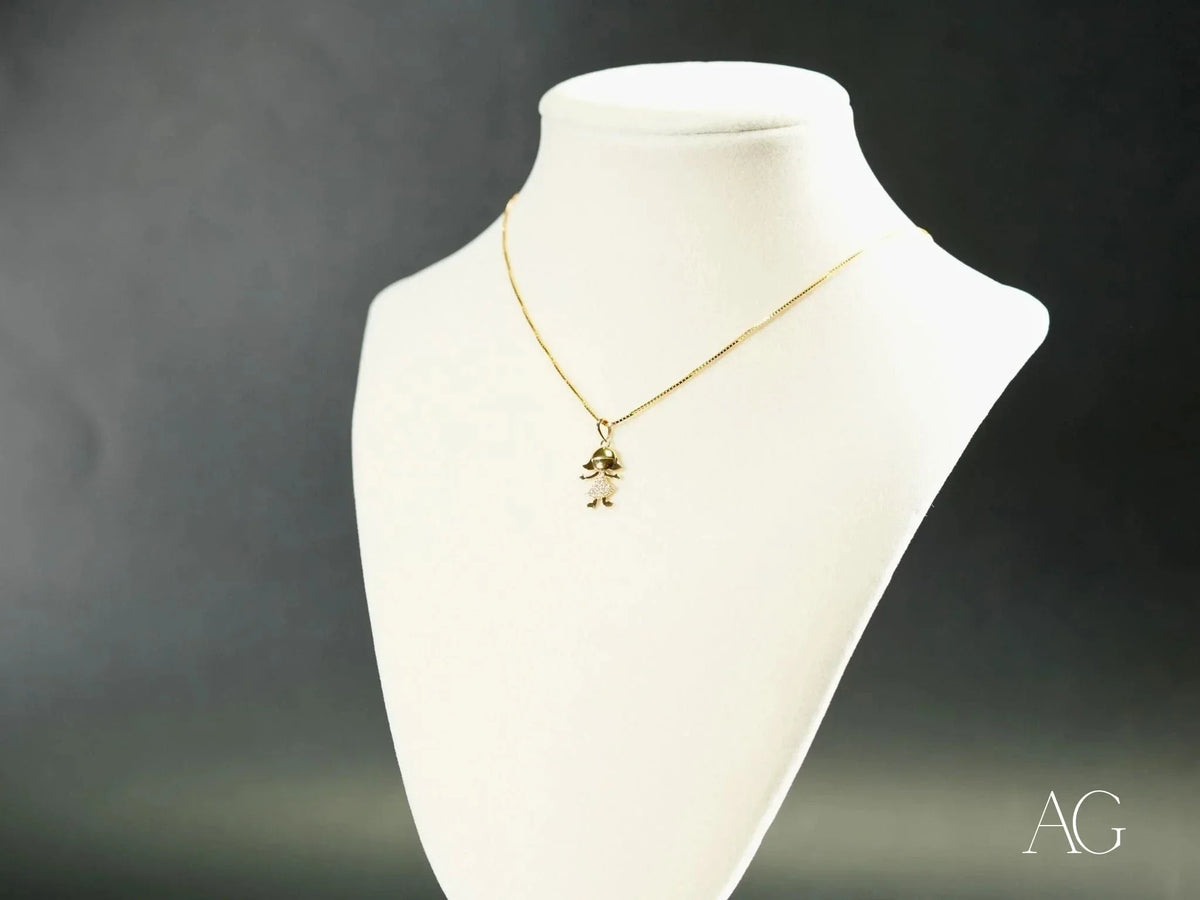 Golden charm doll pendant in art gold jewelry with boy or girl figure