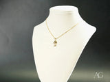Golden charm doll pendant in art gold jewelry with boy or girl figure