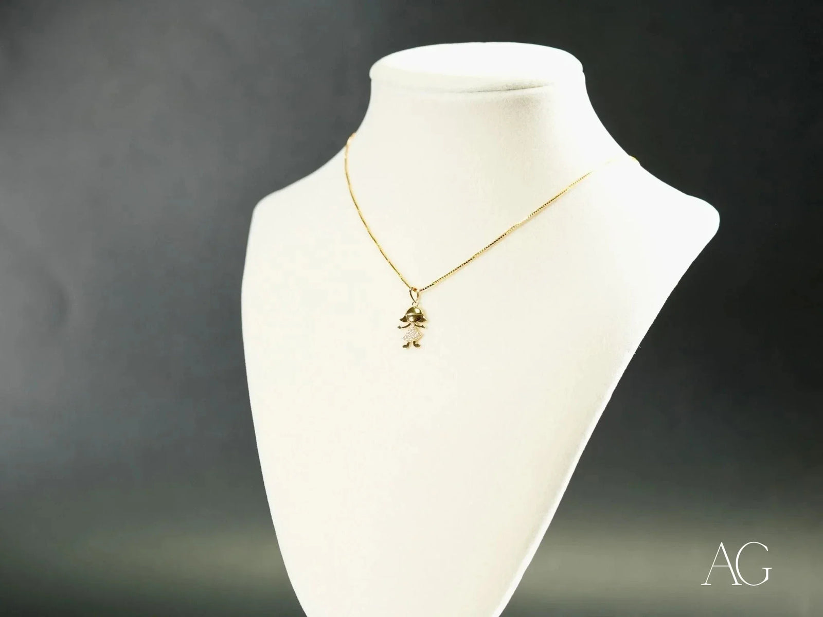 Golden charm doll pendant in art gold jewelry with boy or girl figure