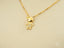 Golden charm doll charm doll pendant featuring a boy-shaped pendant with small diamonds