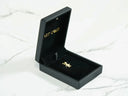 Open Art Gold jewelry box with golden charm doll pendant inside