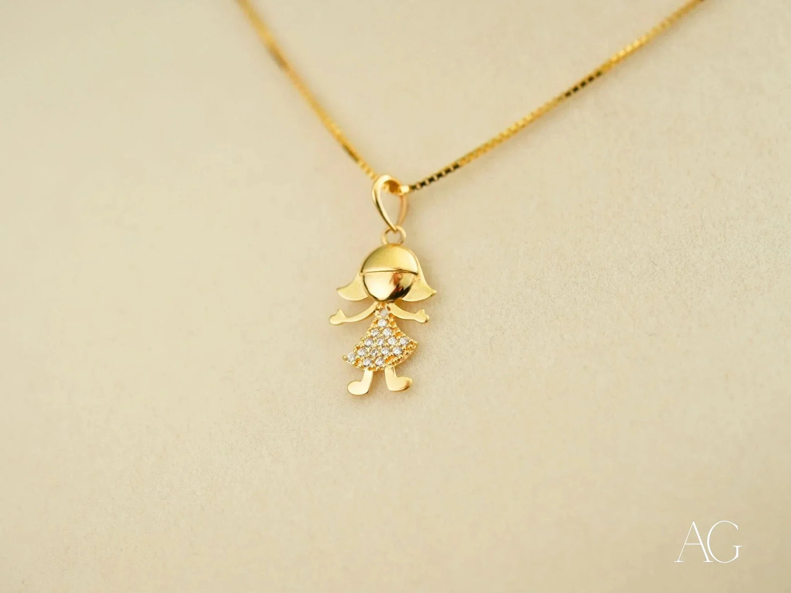 Golden charm doll pendant in art gold jewelry with diamond dress