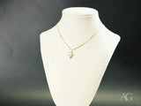 18k solid gold Golden Cherub mini charm pendant on display
