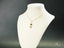 Gold-tone necklace with a figurine pendant featuring a clear stone, part of the Golden Doll Pendant collection in 18k solid gold art gold jewelry
