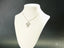 Silver-toned necklace with a girl-shaped pendant, part of Golden Doll art gold jewelry collection