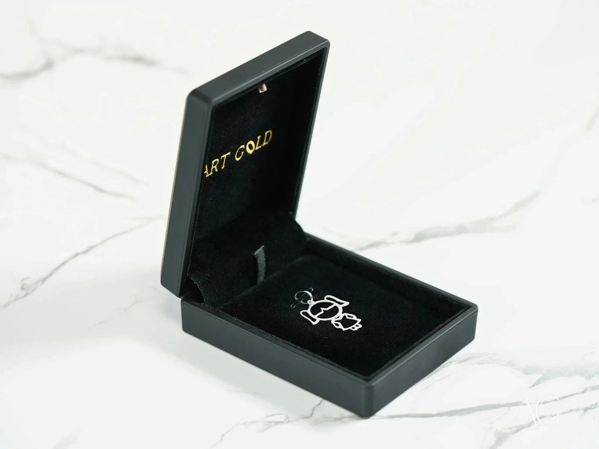 Open 18k yellow gold doll girl pendant in black jewelry box